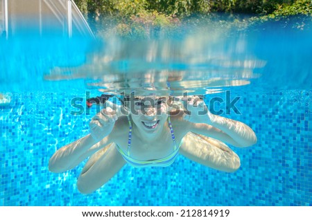 Child swims in swimming pool, playing and having fun, underwater and above view, kids sport and vacation