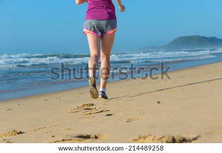 Woman running on beach, beautiful girl runner jogging outdoors, training for marathon, exercising and fitness concept