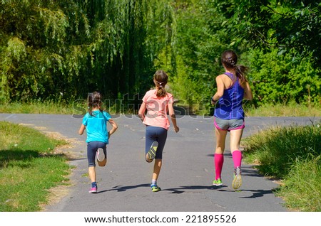 Family sport, mother and kids jogging outdoors, running in park