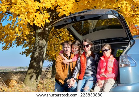 Car trip on autumn family vacation, happy parents and kids travel and have fun, car insurance concept