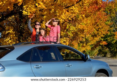 Car trip on autumn family vacation, happy mother and kids travel and have fun, car insurance concept