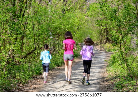 Family sport, happy active mother and kids jogging outdoors, running in forest
