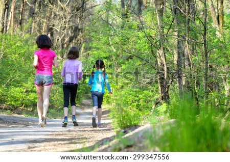 Family sport, happy active mother and kids jogging outdoors, running in forest