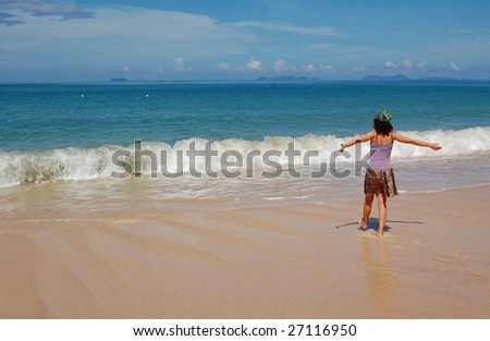 Happy woman looking at the waves