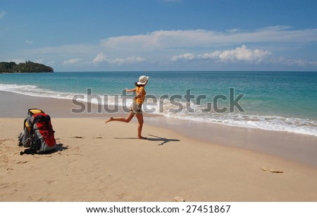 Tropical beach vacation, backpacker style. Arriving to paradise, woman running to sea