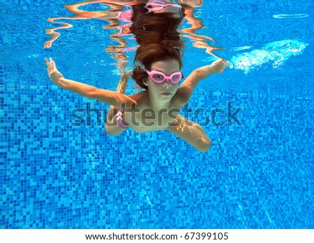 stock photo Active underwater kid in swimming pool Girl swims and having