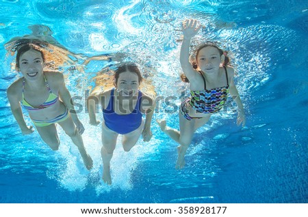 Family swim in pool or sea underwater, happy active mother and children have fun under water, kids sport on family vacation