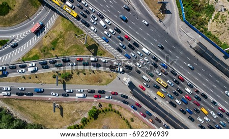 Aerial top view of road junction from above, automobile traffic and jam of many cars, transportation concept