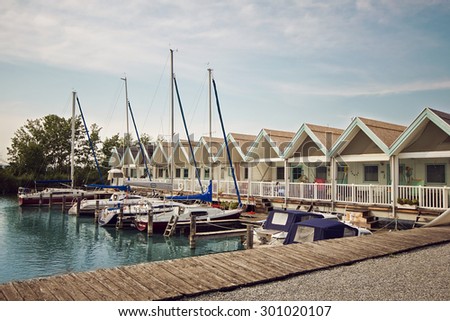 Weiden am See/Austria - July 23 2015: Small beautiful summer cottage on the Neusiedler See lake with a pier for boats and yachts
