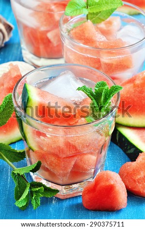 Refreshing summer watermelon drink with mint and ice cubes, selective focus, toned image.