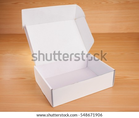 Open blank white box mock up on wood background.