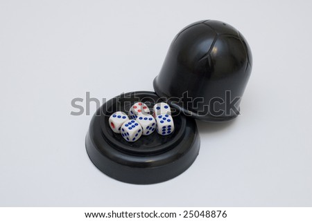 thrown dices and dice cup