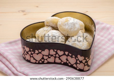 Small cookies in powdered sugar in a tin box in heart shape 6