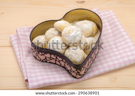 Small cookies in powdered sugar in a tin box in heart shape 2