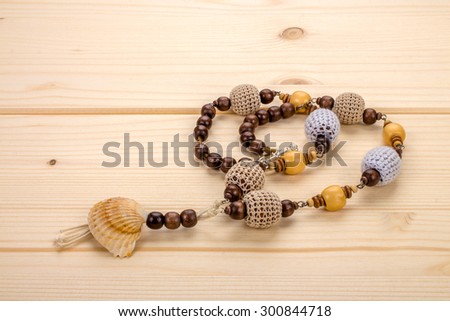 Necklaces handmade with brown and white crocheted beads, sea shells
