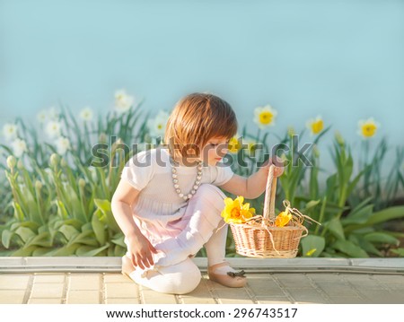 Little girl with a basket of flowers