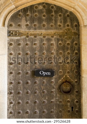 Historic gate with sign \'open\' at the University of Cambridge