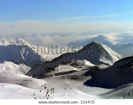 skier in swiss alps, seen from top of a hill