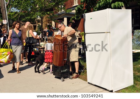 OTTAWA, CANADA - MAY 26: Thousands of people gather at the annual Glebe neighborhood garage sale which takes place for several blocks in the Glebe area of Ottawa, Ontario May 26, 2012.