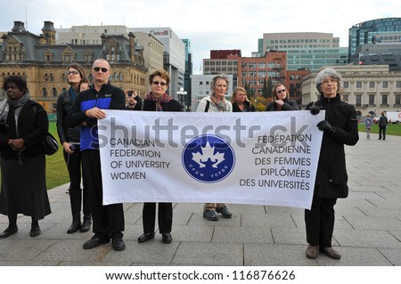 OTTAWA, CANADA  OCT 25:  Unidentified people hold a sign for the CFUW at a demonstration for a call for a national plan to end violence against women on Parliament Hill Oct 25, 2012 in Ottawa.