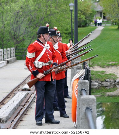 MANOTICK, CANADA - MAY 1:  Actors in period costumes perform gun salute during the opening day of the Watson\'s Mill Museum May  1, 2010 in Manotick, Ontario.