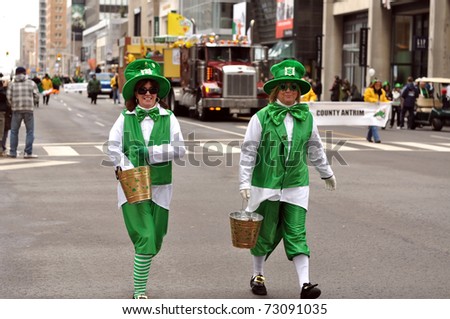 TORONTO, CANADA - MARCH 13: Two women pass out chocolate treats as part of the St. Patrick\'s Day Parade March 13, 2011 in Toronto, Ontario.