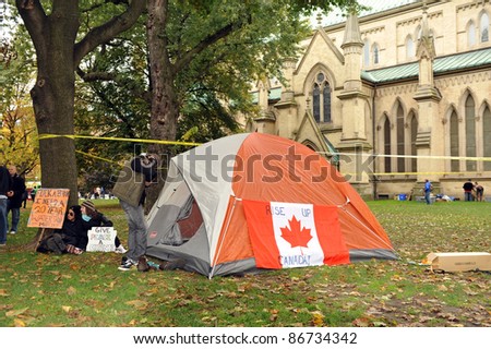 TORONTO, CANADA – OCT 15:  Unidentified demonstrators set up a tent at Saint James Park in downtown Toronto, for the Toronto version of Occupy Wall Street, Oct. 15 2011 in Toronto, Canada.