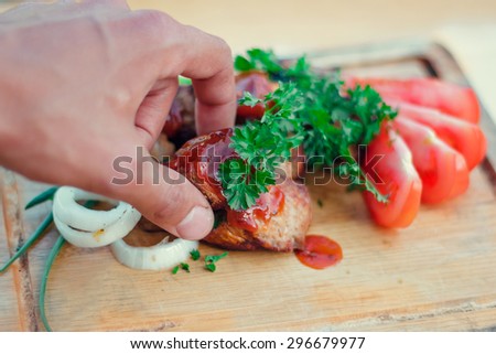 hand takes a piece of meat