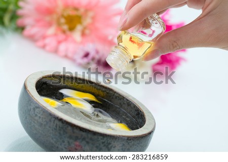 Essential oil dripping into water