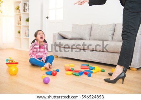 business woman back from office and see her daughter play toys messy up the living room feel angry and criticize the sadness asian kid girl at home.