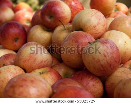 Red and yellow apples stacked for sale.