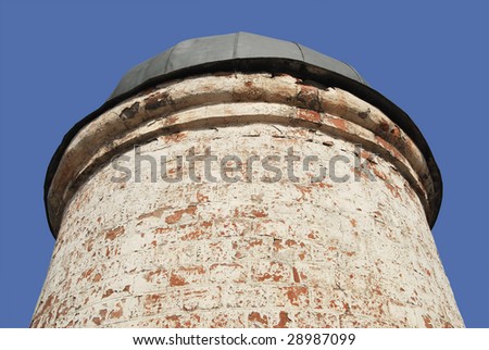 Background of small ancient round brick tower isolated.
