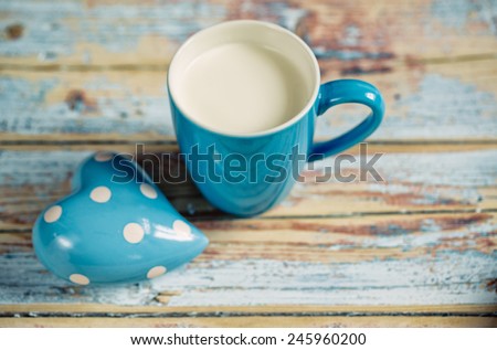 Blue Cup filled with fresh warm Milk