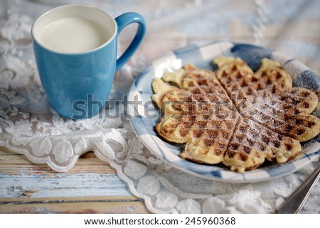 Freshly baked warm crisp Waffle with Icing sugar with Cup of Fresh Milk