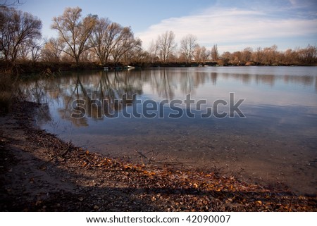 Small Lake with Trees in Autumn, with reflections in the water