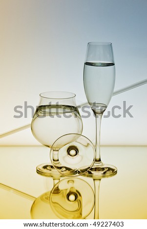 Champagne glasses on Mirror surface and smooth gradient background