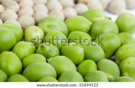 Fresh green peas and dried peas isolated on white studio shot