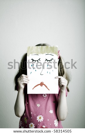 stock photo : Little blonde girls holding sad face mask