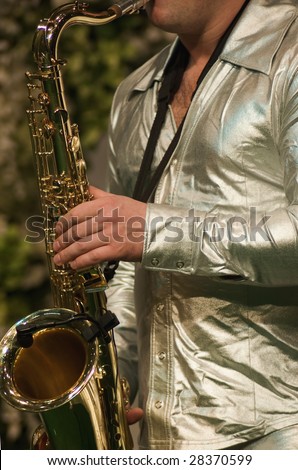 A man playing his wind instrument with expression.