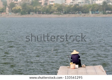 The sign of a fishing man\'s back on pier, in Lianchi Lake, Kaohsiung, Taiwan.