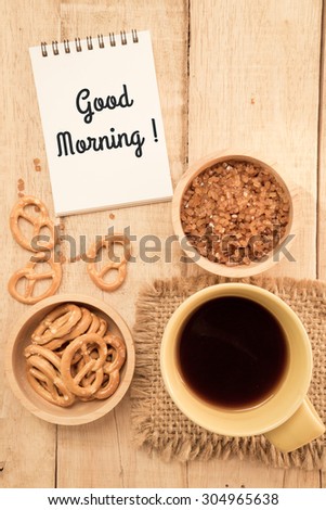 Cup of coffee and cookies , caramel  sugar on the table. Good morning note