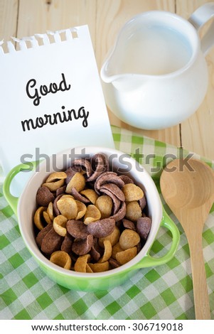 Cereal in a bowl with milk with good morning note