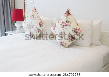Bed with white sheets and lamps