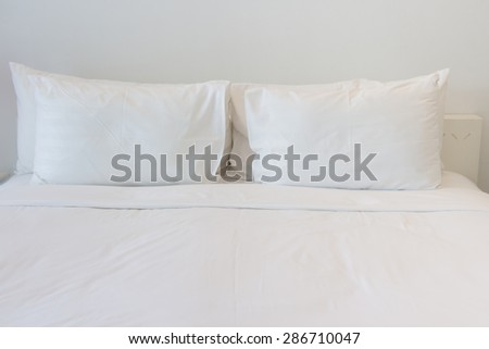 White pillows on empty bed