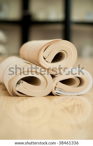 Rolled education book with reflection on the wood table