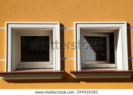 Two square windows, one open