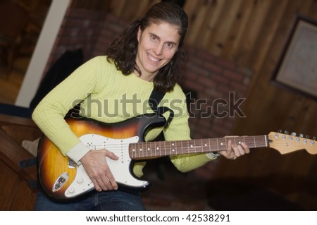 Middle aged woman electric guitar player