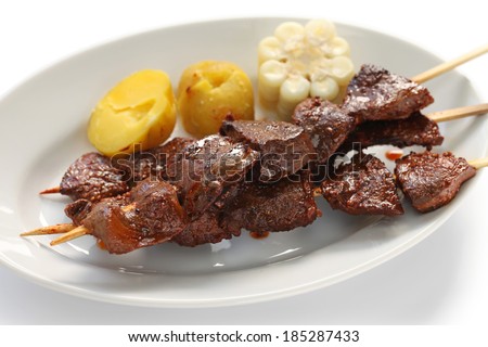 anticuchos, Peruvian cuisine, grilled skewered beef heart meat with boiled potato and white corn