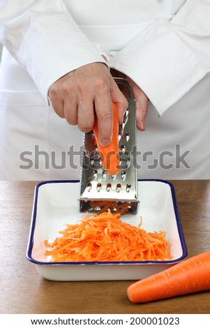 making grated carrot salad, shredding carrots
