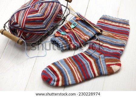 knitting winter warm socks, yarn ball and knitting needles, handmade christmas present